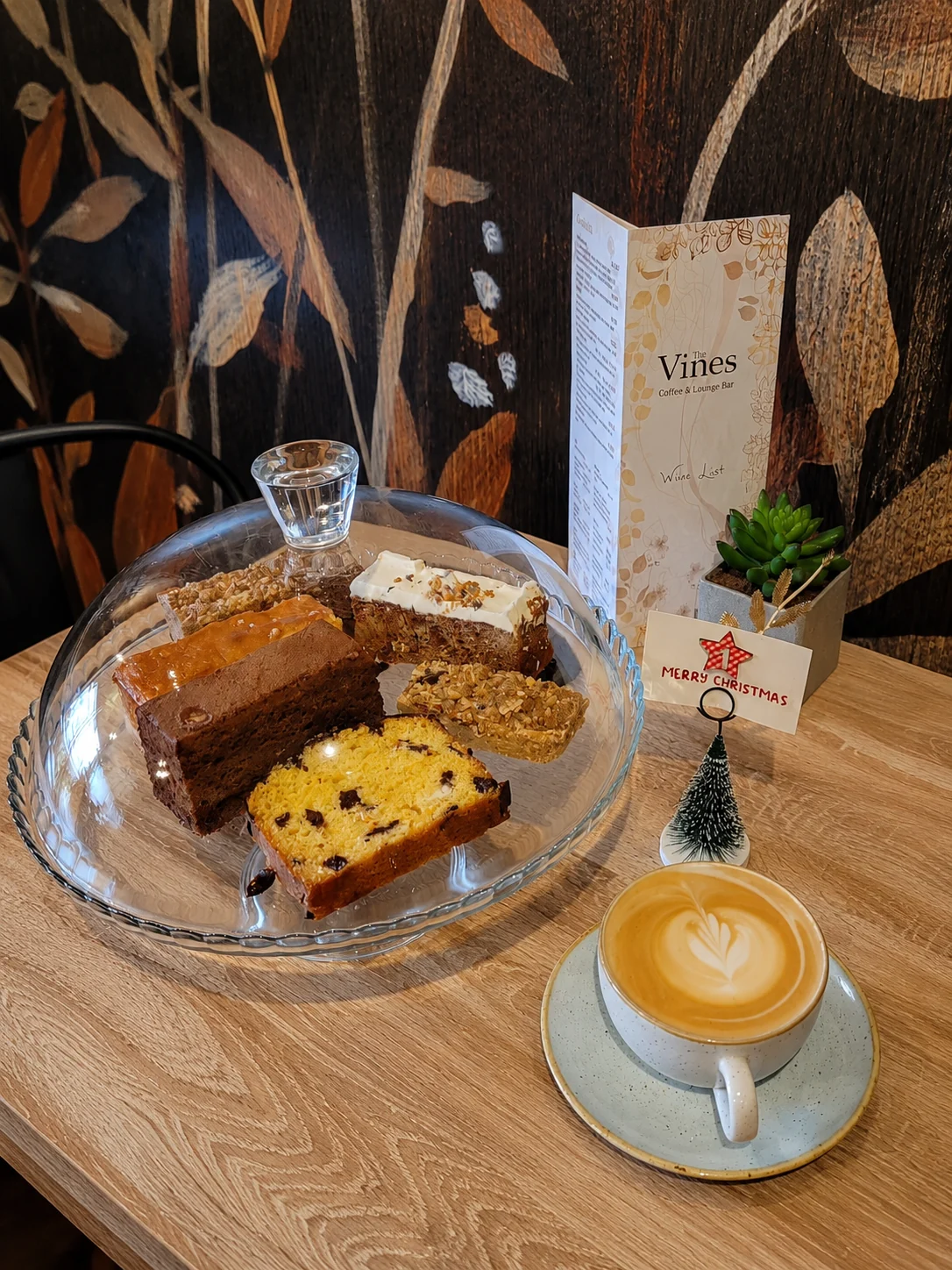 Selection of cakes displayed beside a coffee at The Vines